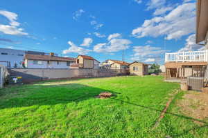 Fenced backyard featuring stairs and a patio area