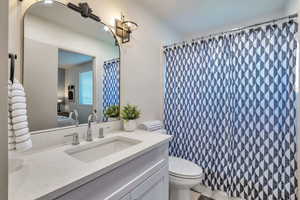 Full bath with vanity, a shower with curtain, and connected bathroom