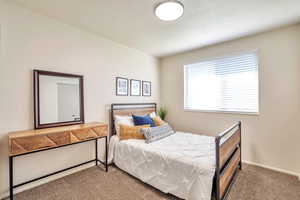 Carpeted bedroom with baseboards