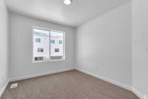 Spare room with carpet and a textured ceiling