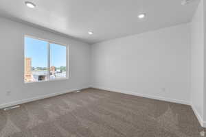 Spare room with carpet flooring, recessed lighting, and a textured ceiling