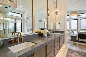 Bathroom featuring parquet floors, double vanity, recessed lighting, a stall shower, and ensuite bathroom
