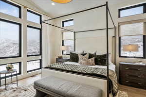 Bedroom with wood finished floors and recessed lighting