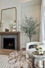 Living area featuring wood finished floors and a lit fireplace