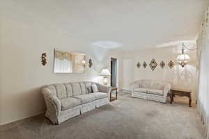 Living area featuring carpet and baseboards