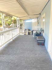 View of patio with a sunroom