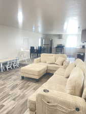 Living room with wood finished floors and a textured ceiling