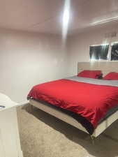 Carpeted bedroom with baseboards