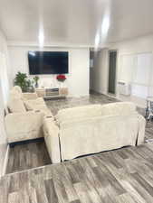 Living room with dark wood-style flooring and baseboards