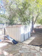 View of shed with a fenced backyard