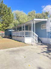 Manufactured / mobile home with covered porch and concrete driveway