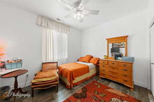 Bedroom featuring dark wood-style floors and ceiling fan