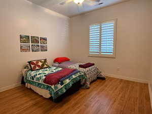 Bedroom with wood finished floors and ceiling fan
