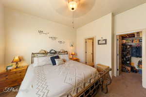 Carpeted bedroom featuring a closet and a ceiling fan