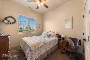 Carpeted bedroom featuring ceiling fan and baseboards