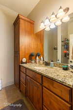 Bathroom with vanity and a tile shower