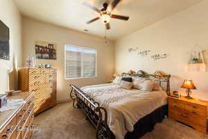 Bedroom with carpet and a ceiling fan