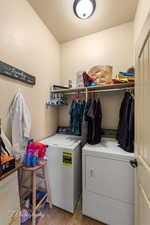 Laundry area featuring washing machine and dryer and a textured ceiling