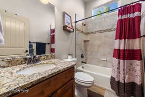 Full bath featuring shower / tub combo and vanity