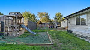 View of play area with a fenced backyard