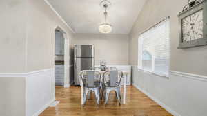 Dining area featuring light wood-style floors and a chandelier