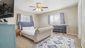 Bedroom featuring light colored carpet and ceiling fan