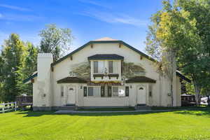 View of front of Condo (Unit on Left) featuring a front lawn, stucco siding, a chimney, and entry steps