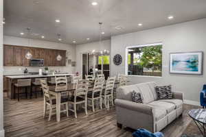 Dining area with recessed lighting, a chandelier, dark wood finished floors, and a textured ceiling