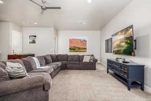 Living area featuring light carpet, recessed lighting, and a ceiling fan
