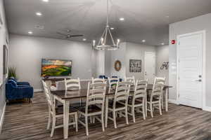 Dining area with recessed lighting, ceiling fan, a chandelier, and dark wood-style floors