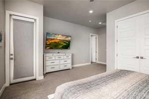 Bedroom featuring carpet, recessed lighting, and a textured ceiling
