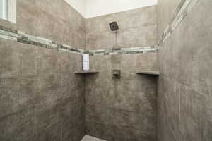 Bathroom featuring a tile shower