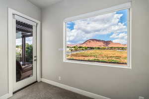 Doorway with a mountain view and carpet flooring