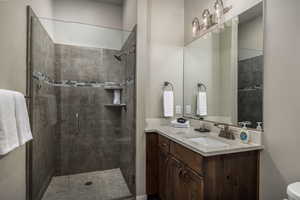 Bathroom featuring vanity and a shower stall