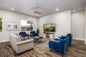 Living room featuring ceiling fan, recessed lighting, and dark wood-style flooring