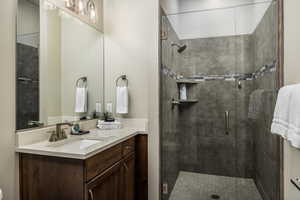 Bathroom with vanity and a stall shower