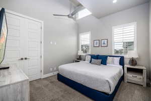 Bedroom with dark carpet, a closet, and ceiling fan