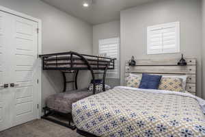 Bedroom with carpet flooring, a closet, and a ceiling fan