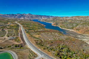 Aerial view of property's location with a water and mountain view