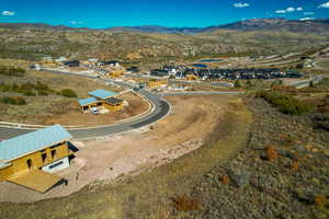 Aerial view of property's location with nearby suburban area and a mountain backdrop