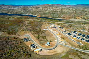 Aerial view of property and surrounding area with a water and mountain view