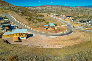 Aerial view of property's location with a mountainous background