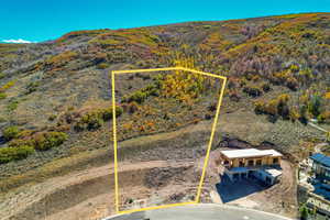 Aerial view of property and surrounding area featuring property parcel outlined