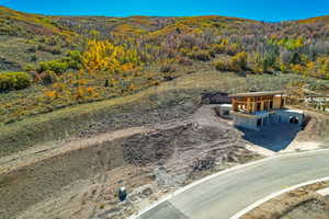 View of subject property featuring a forest and a mountain backdrop
