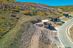 View of subject property featuring a mountainous background and a heavily wooded area