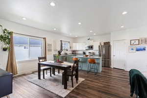 Dining space with recessed lighting and dark wood-style floors
