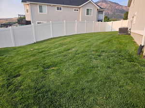 Fenced backyard with a mountain view