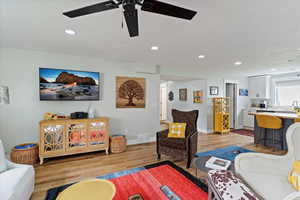 Living room featuring light wood-style floors, recessed lighting, and ceiling fan