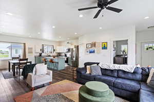 Living area with recessed lighting, dark wood finished floors, and a ceiling fan