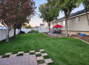 Backyard with porch, mature trees and fully fenced